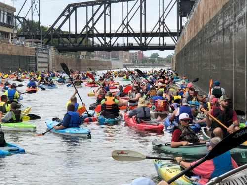 kayakers going through lock and dam on river