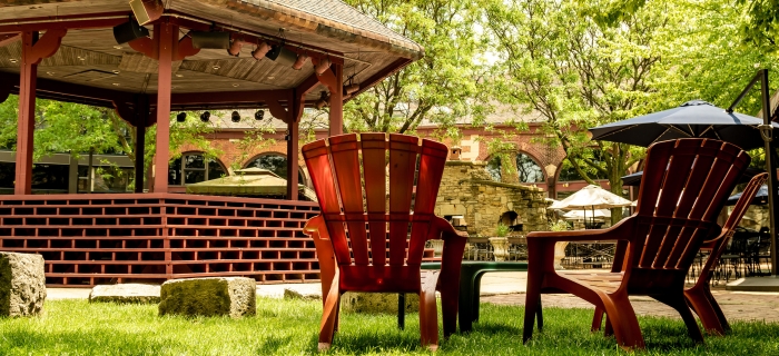2 Adirondak chairs sitting next to a gazebo