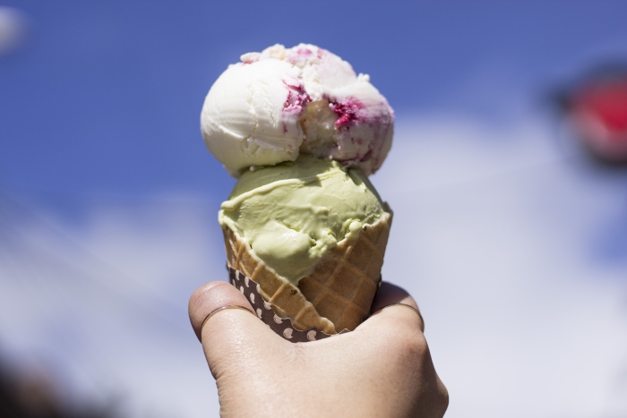 hand holding double scoop sugar ice cream cone