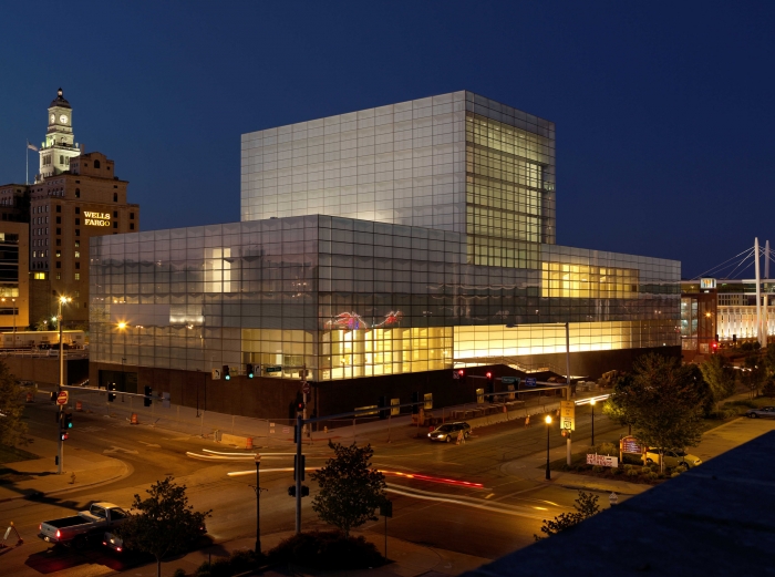 large glass museum at night in city