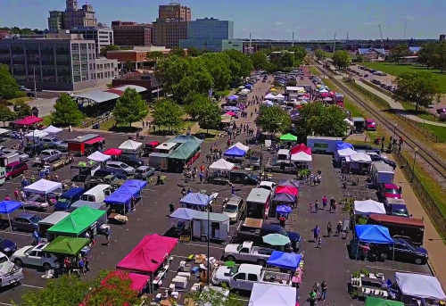 aerial of outdoor farmers market in a large downtown parking lot