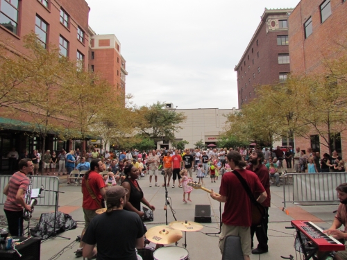 downtown street plaza with live music band spectators