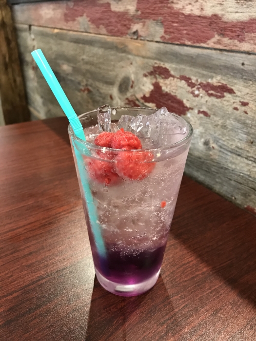 fizzy clear energy drink in to go glass with straw