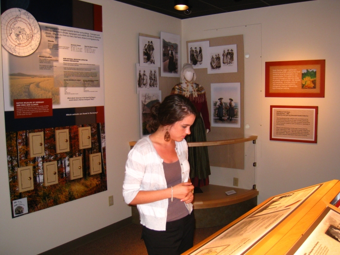 young woman looking at museum exhibit