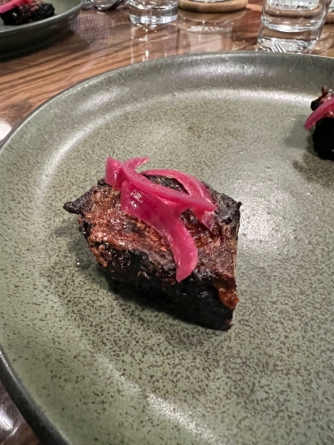 Brown meat on white plate