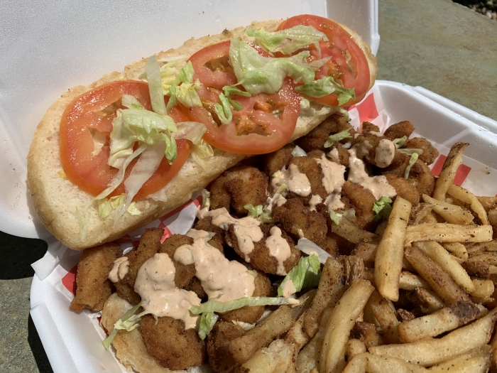 bettered bites of fish on hoagie roll with lettuce and tomato on hoagie roll with remoulade sauce served with fries
