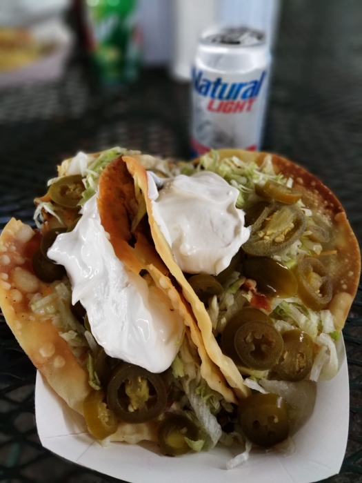 2 fried sheel tacos with beef, lettuce, jalapenos, and sour cream