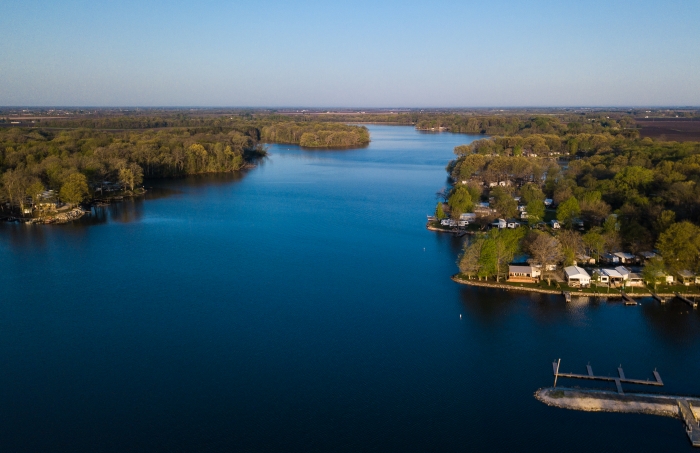 aerial view of river on clear day with tree-lined river banks
