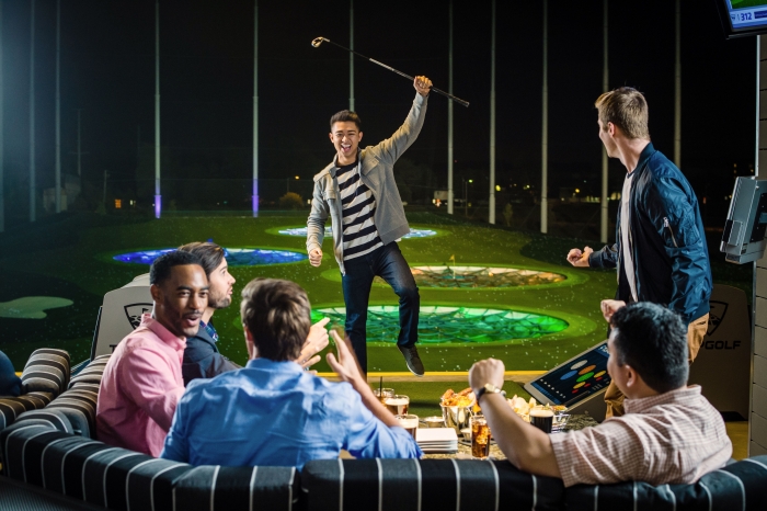 group of guys at indoor golf facility having a drink