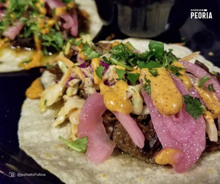 soft corn shell taco with sliced beef, kimchi, and slaw