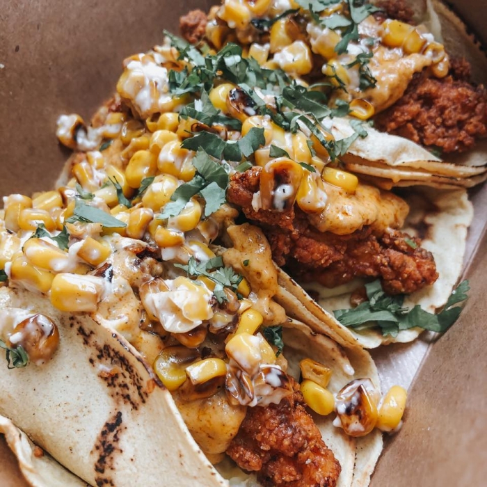 3 soft flour sheel tacos with fried shrimp, elote corn, and cilantro