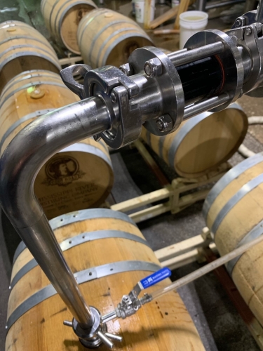 emptying beer thsat has aged in weooden whiskey barrels