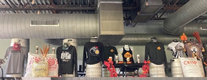 brewery merchandise displayed with shirts, tanktops, hats, and more