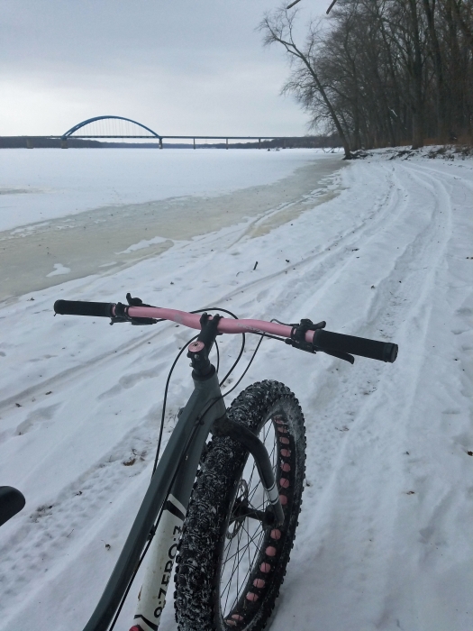 looking at winter trail along river from bicycle seat