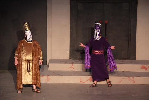 theatre show of greek play with 2 men in large greek masks