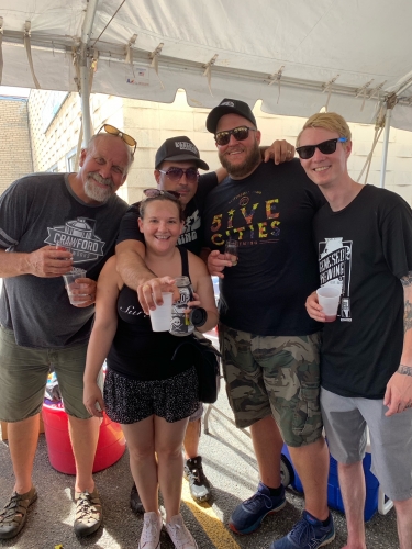 group of 5 brewers outside under tent